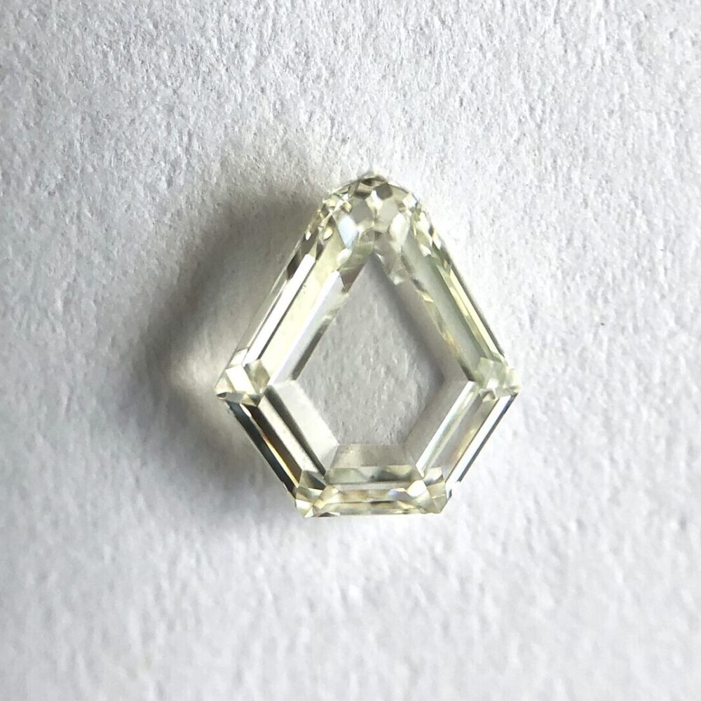 Shield shape K color step cut diamond