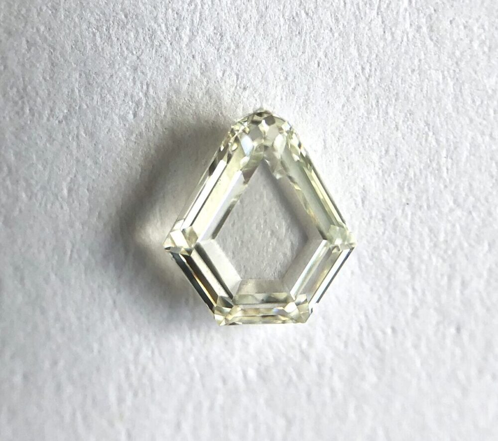 Shield shape K color step cut diamond